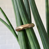 Denali carved chunky faceted yellow gold wedding band in natural light 