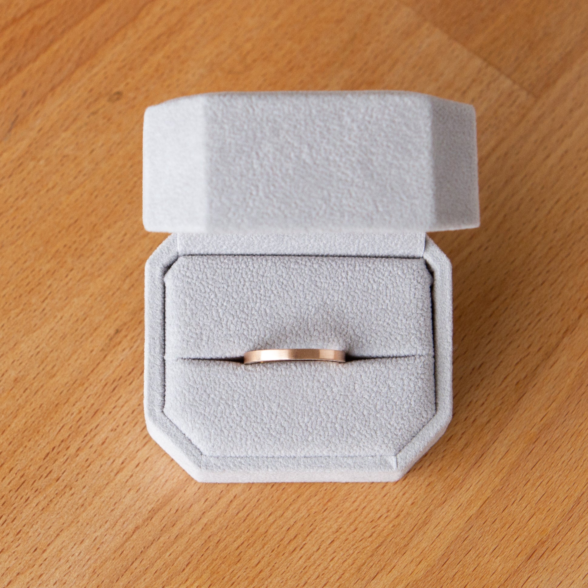 Thin Diablo flat brushed rose gold wedding band in a ring box