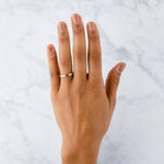 Thin 2mm Diablo flat brushed yellow gold wedding band on a hand by Corey Egan