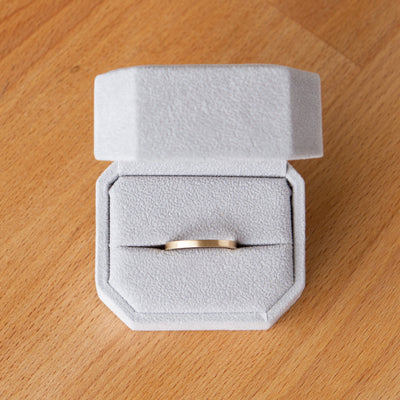 Thin Diablo flat brushed yellow gold wedding band in a ring box