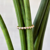 White diamond droplet band in 14k yellow gold by Corey Egan