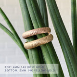 Mackinac half-round carved sandy surface wedding bands in  14k rose gold 4mm wide (top) and 14k yellow gold 5mm wide (bottom)