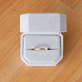 Shiny muir flat thin yellow gold wedding band in a ring box