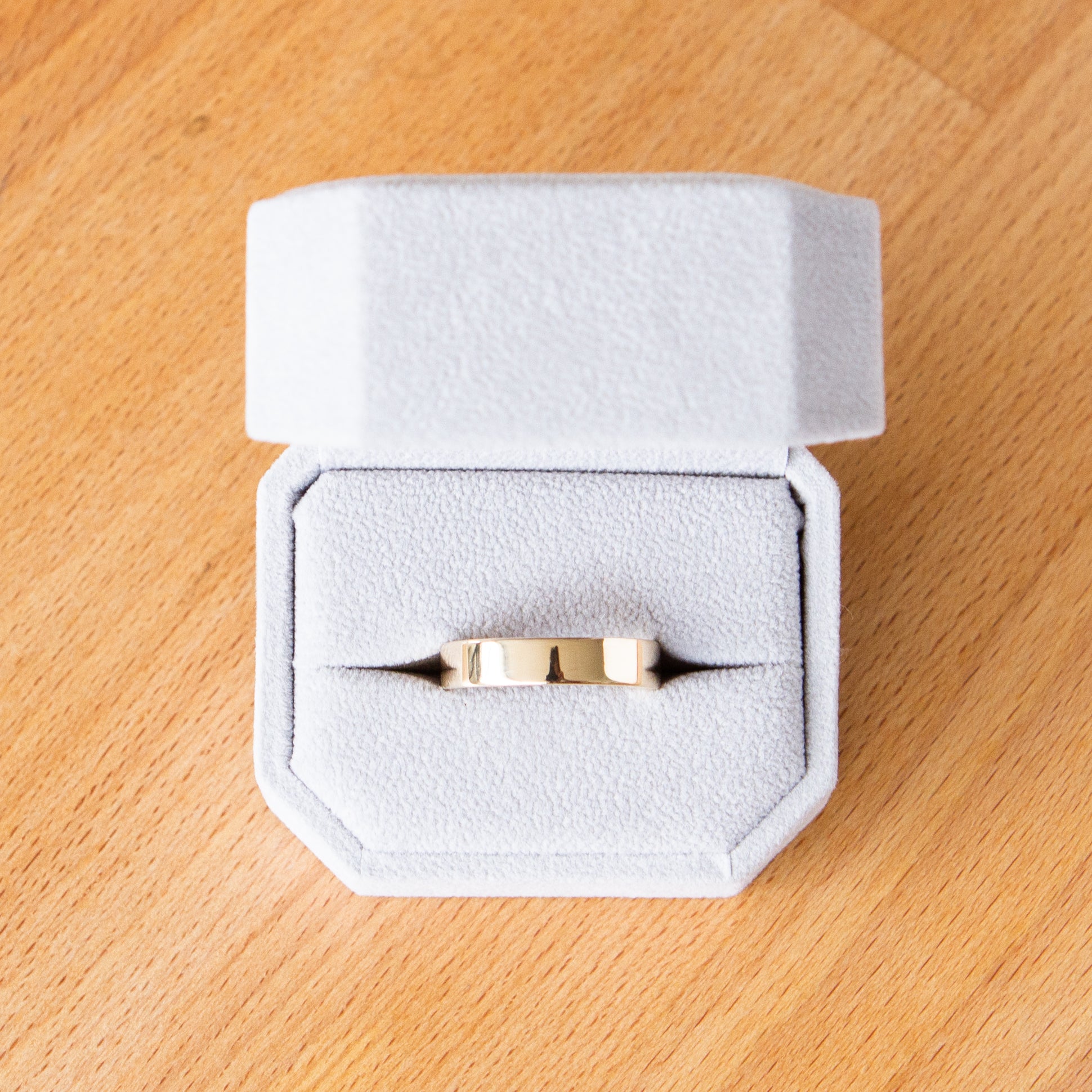 Shiny flat Muir wedding band 5mm wide in a ring box