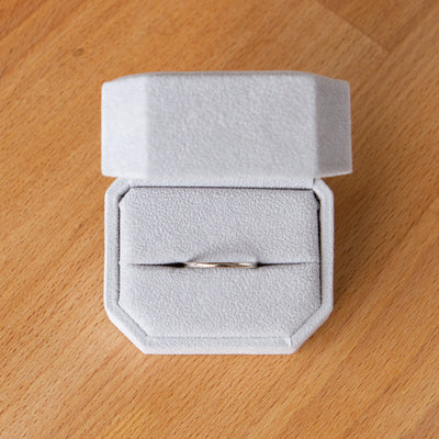 Shiny half-round thin Muir wedding band in 14k white gold in a ring box