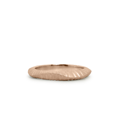 14k rose gold undulating carved texture wedding band by Corey Egan on a white background