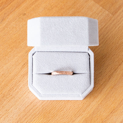 Napali undulating carved texture wedding band in 14k rose gold in a ring box