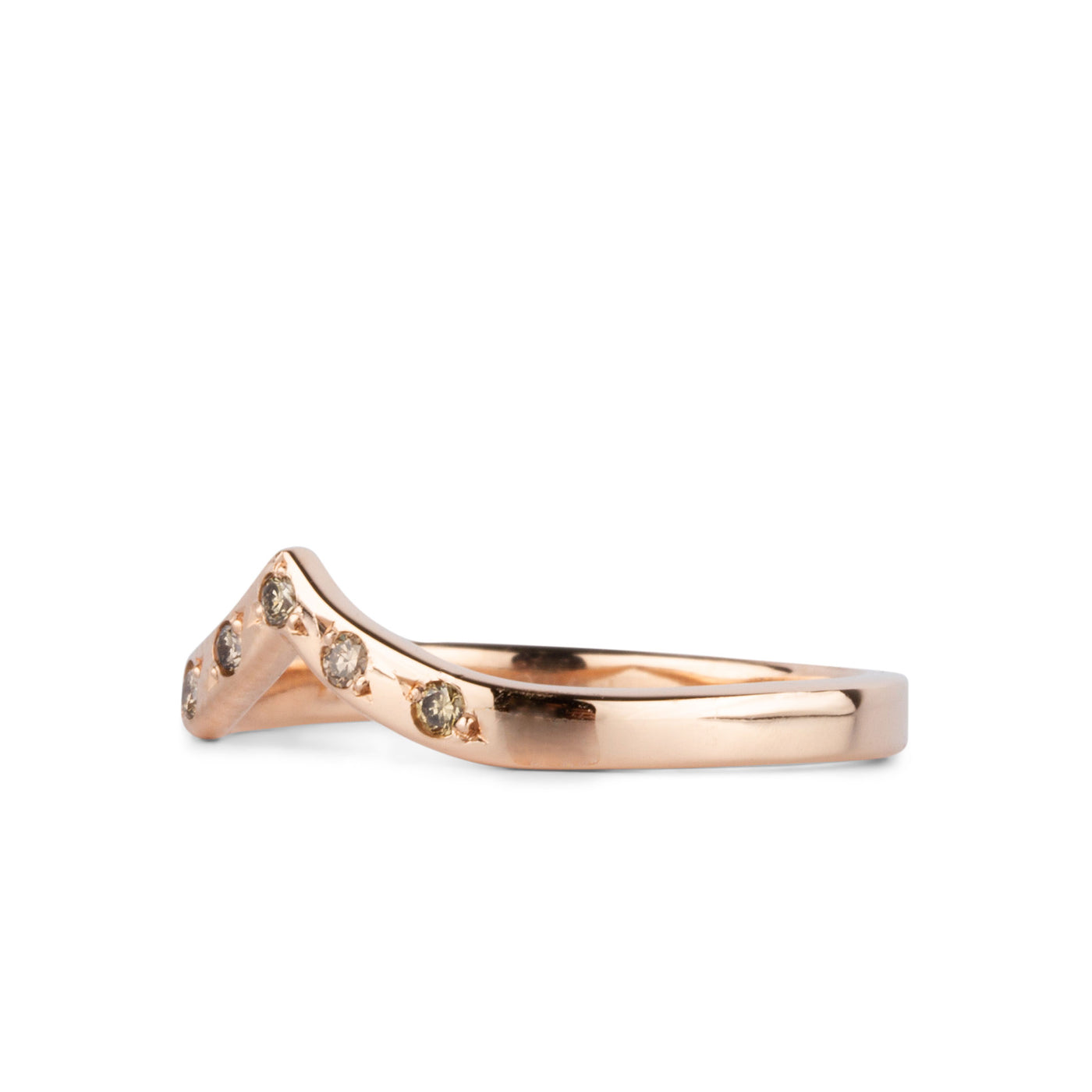 Peaked 14k rose gold band with five champagne diamonds in delicate star settings side view on a white background