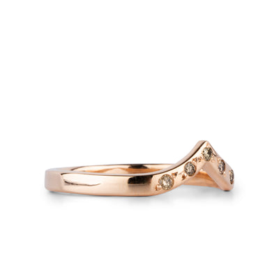 Peaked 14k rose gold band with five champagne diamonds in delicate star settings side view #2 on a white background