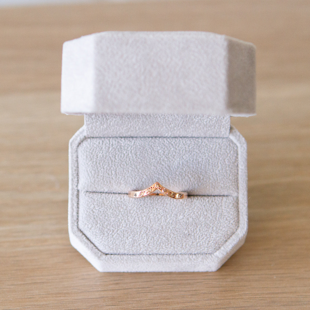 Peaked 14k rose gold band with five champagne diamonds in delicate star settings in a gift box
