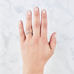 White Diamond Royale pave-set peaked band on a hand