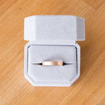 4mm wide rose gold Yosemite flat stippled texture wedding bands in a ring box