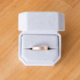 4mm wide rose gold Yosemite flat stippled texture wedding bands in a ring box