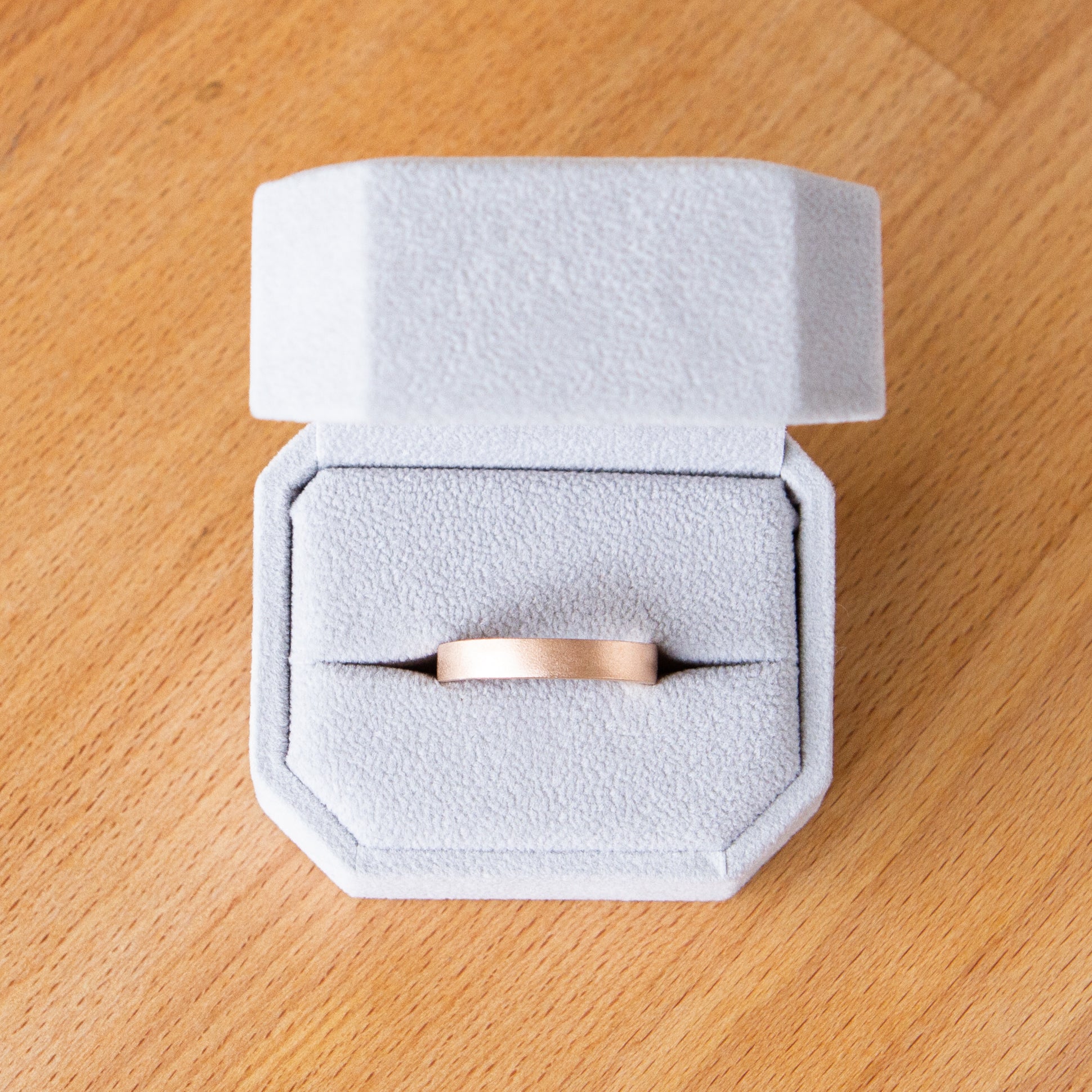 4mm wide rose gold Yosemite flat stippled texture wedding bands in a ring box