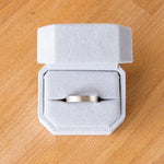 4mm wide white gold Yosemite flat stippled texture wedding bands in a ring box