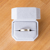 4mm wide white gold Yosemite flat stippled texture wedding bands in a ring box