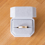 4mm wide yellow gold Yosemite flat stippled texture wedding bands in a ring box