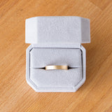 4mm wide yellow gold Yosemite flat stippled texture wedding bands in a ring box