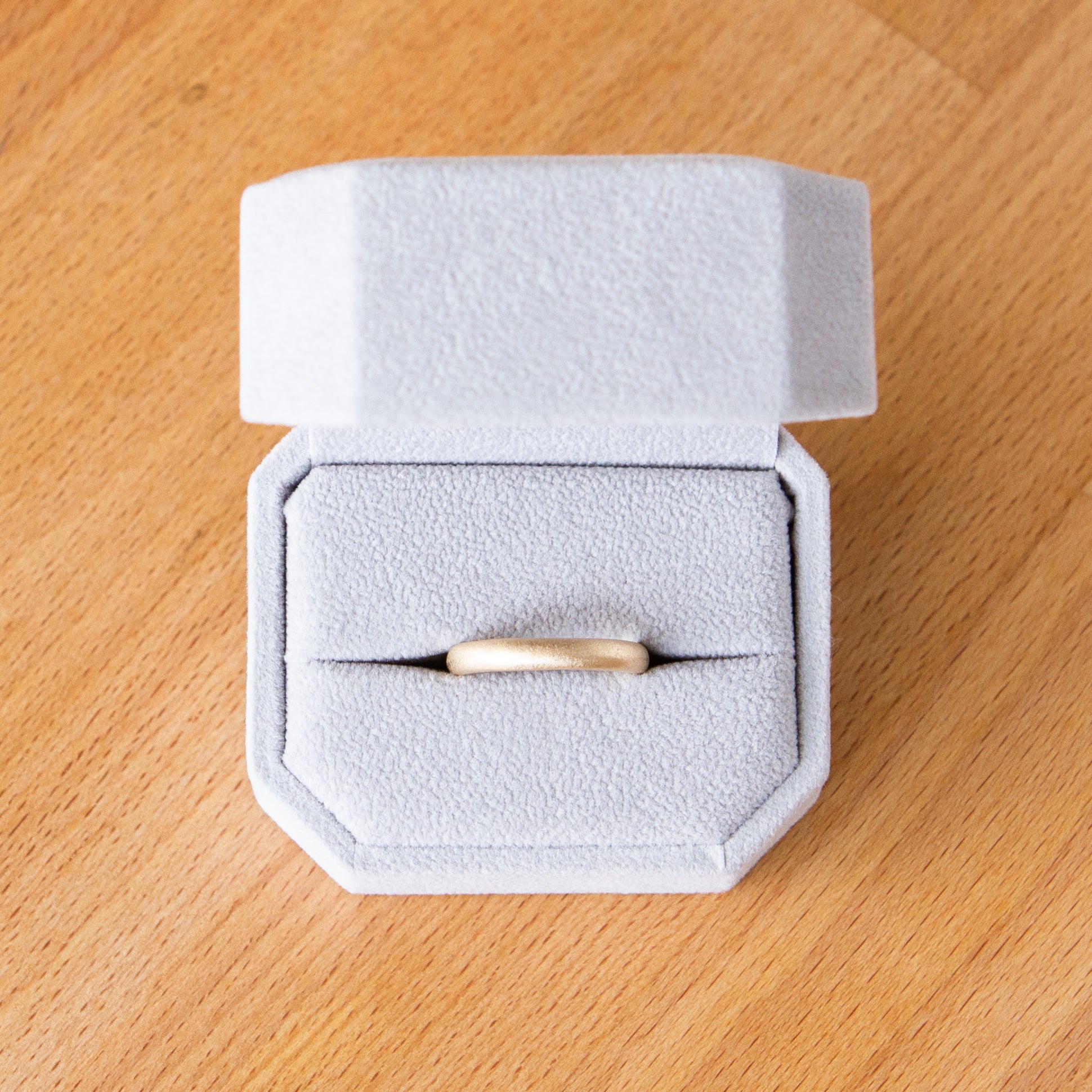 3mm Yellow gold Yosemite half round stippled texture wedding band in a ring box