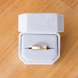 3mm Yellow gold Yosemite half round stippled texture wedding band in a ring box