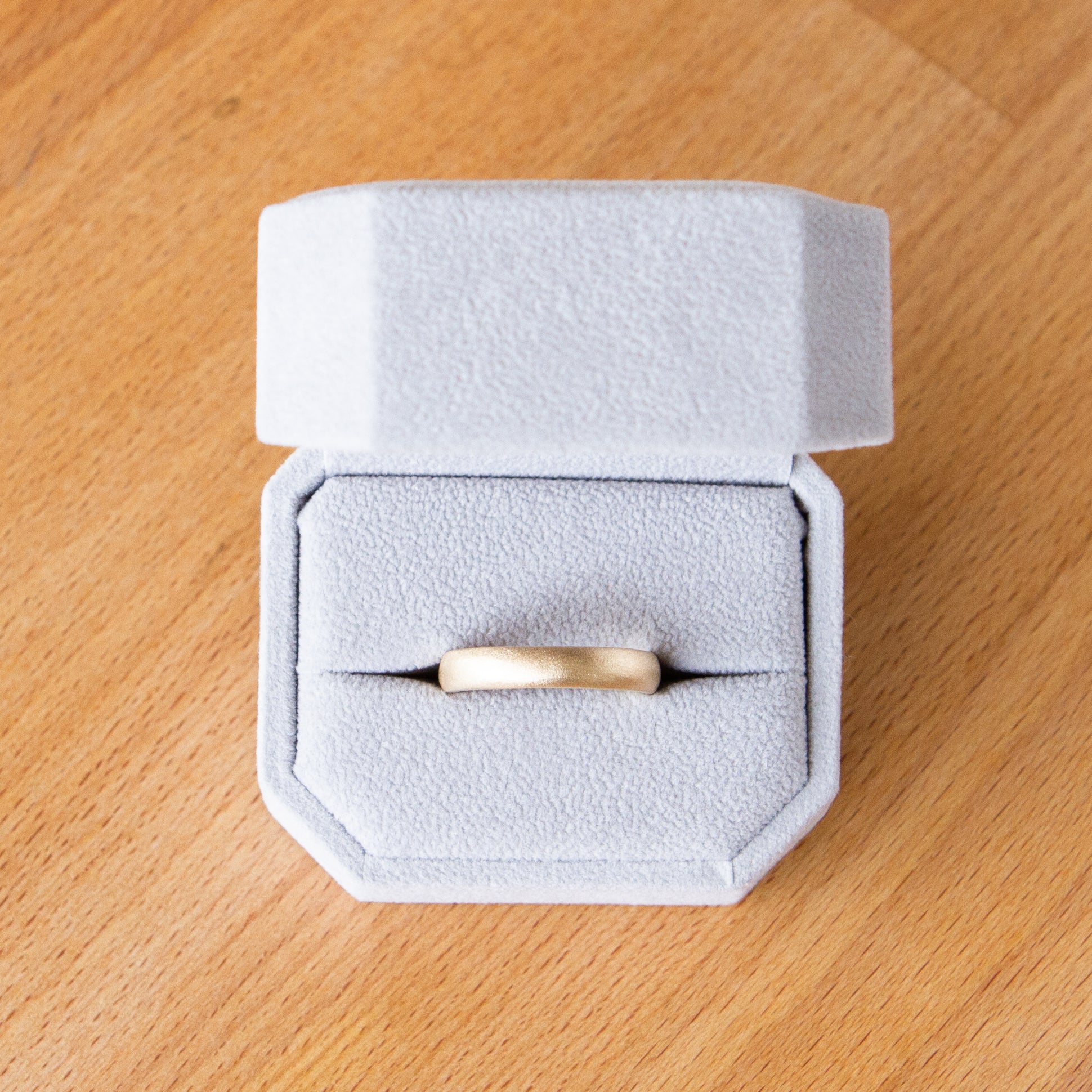 3mm Yellow gold Yosemite half round stippled texture wedding band in a ring box