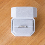 14k white gold thin zion flat vertical hammered wedding band in a ring box