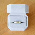 14k white gold Zion Band in a ring box by Corey Egan