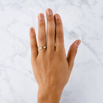 14k yellow gold vertical hammered flat Zion Band on a hand by Corey Egan