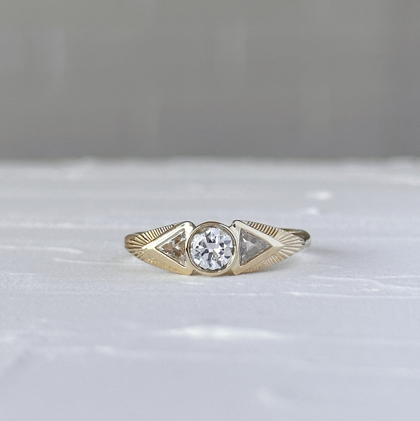 Athena Ring with Old European Cut Diamond in front of a white wall, front angle
