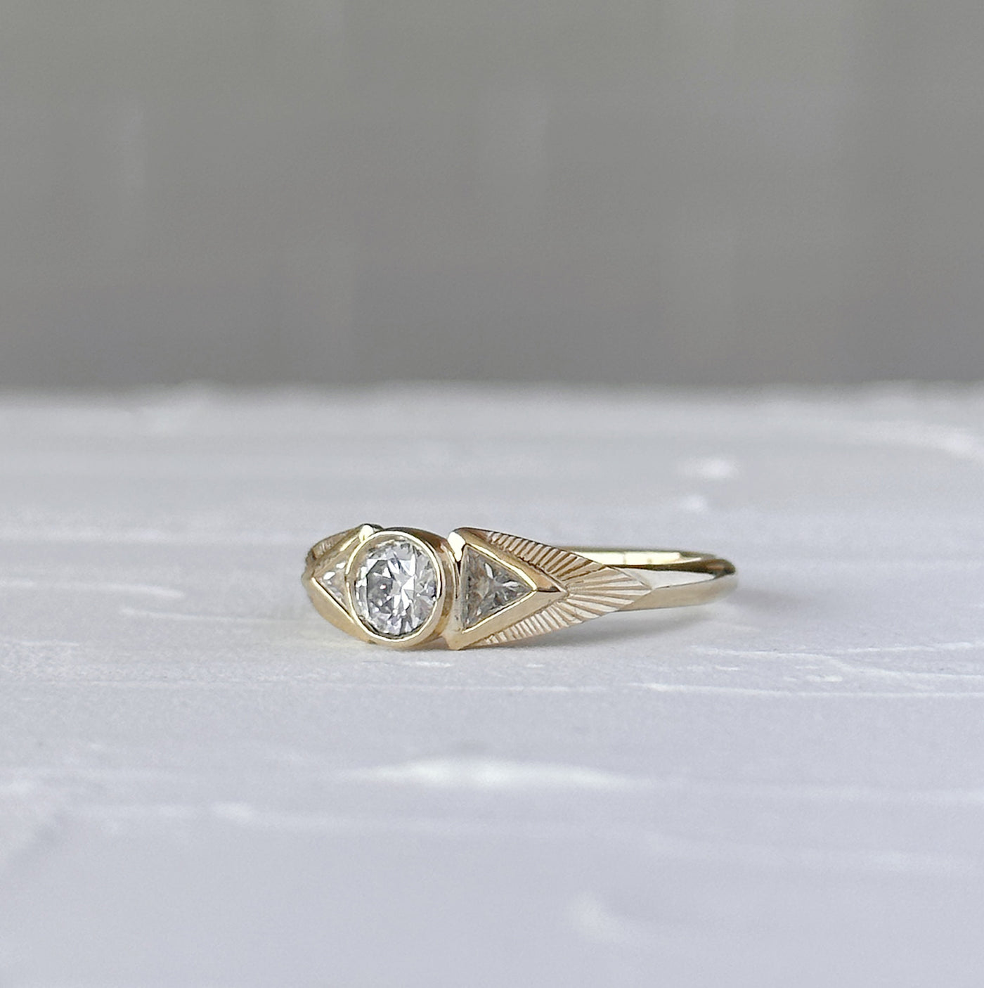 Athena Ring with Old European Cut Diamond in front of a white wall, side angle