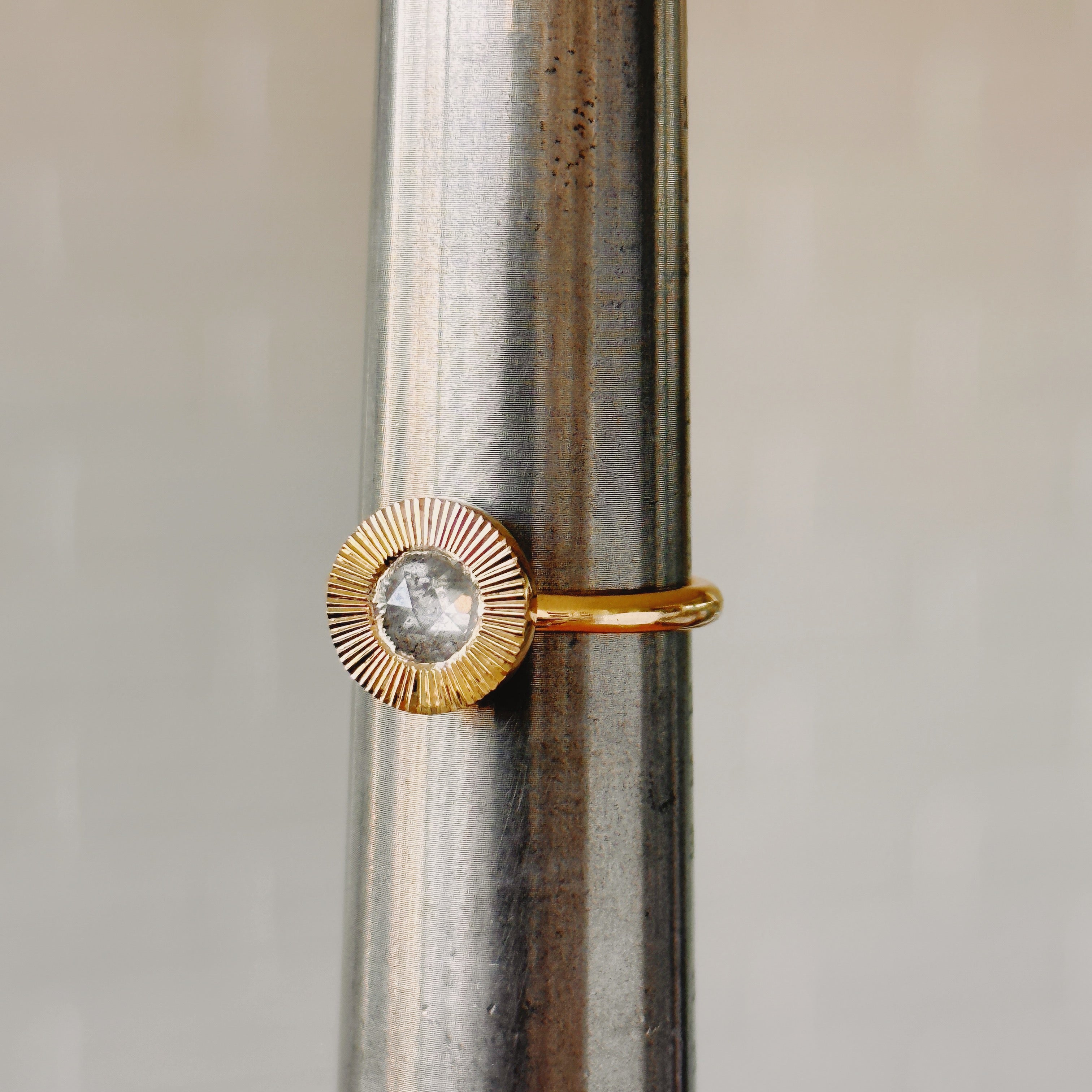 Icy Rose Cut Diamond Aurora Ring side angle on a metal ring sizer