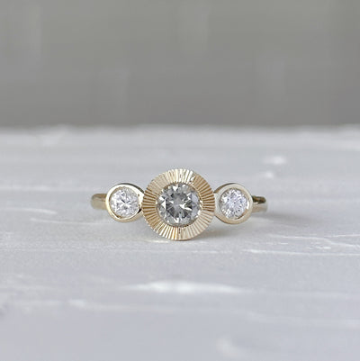 Polaris Ring with Grey Diamond in front of a white wall, front angle