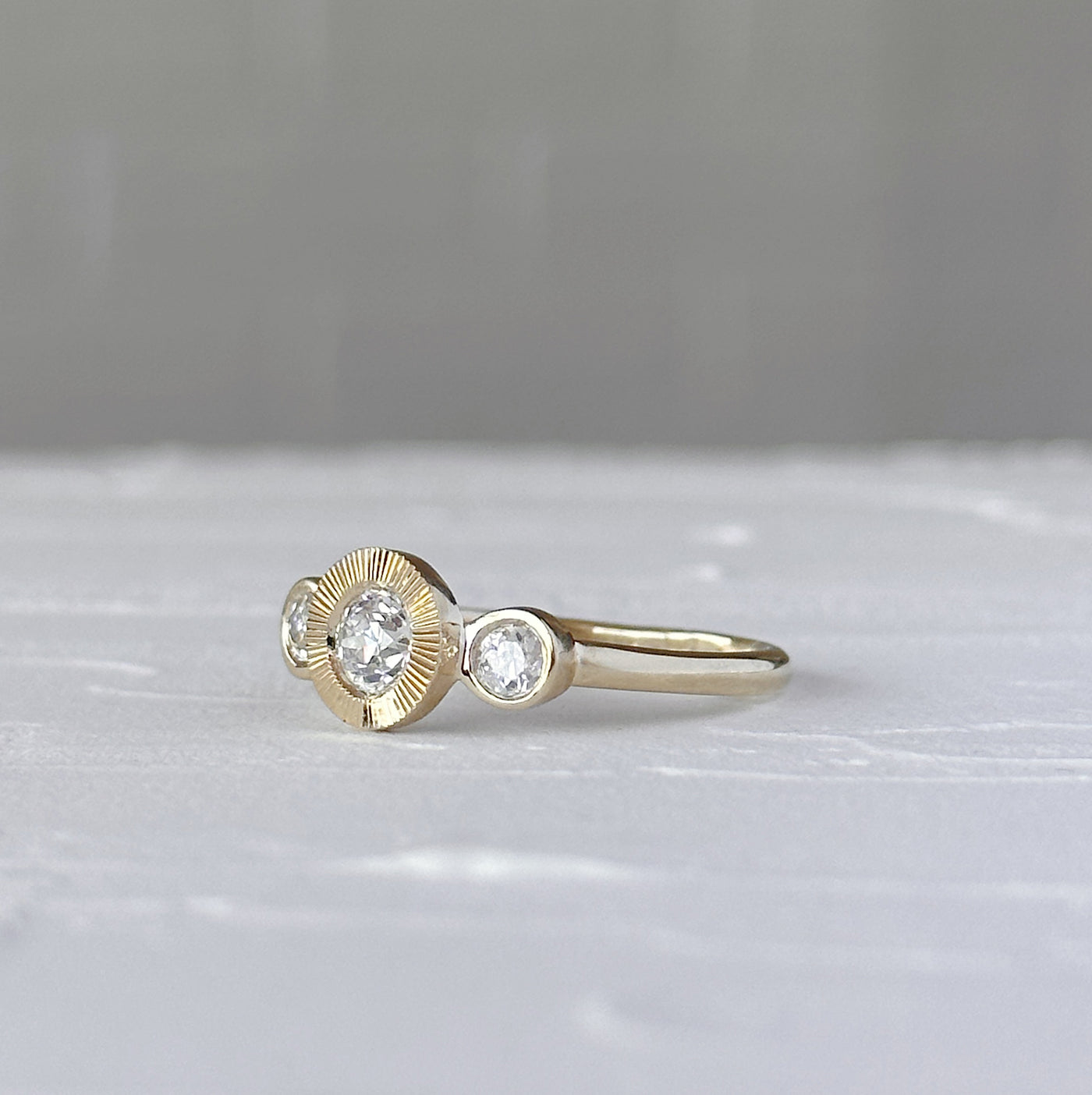 Polaris Ring with Old Mine Cut Diamond in front of a white wall, side angle