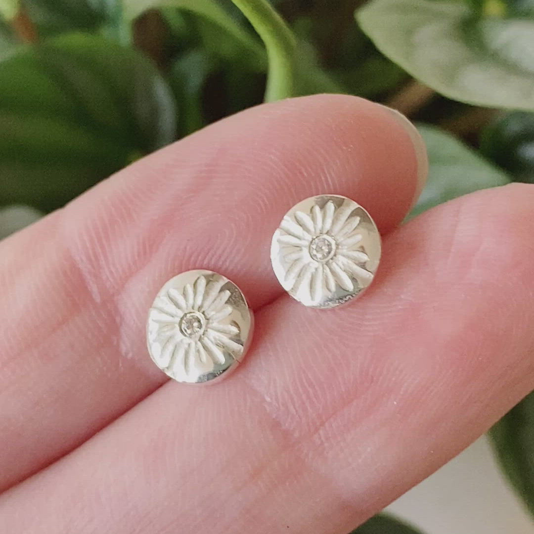 Small Lucia Diamond Stud Earrings between two fingers by Corey Egan