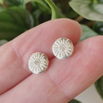 Small Lucia Diamond Stud Earrings between two fingers by Corey Egan