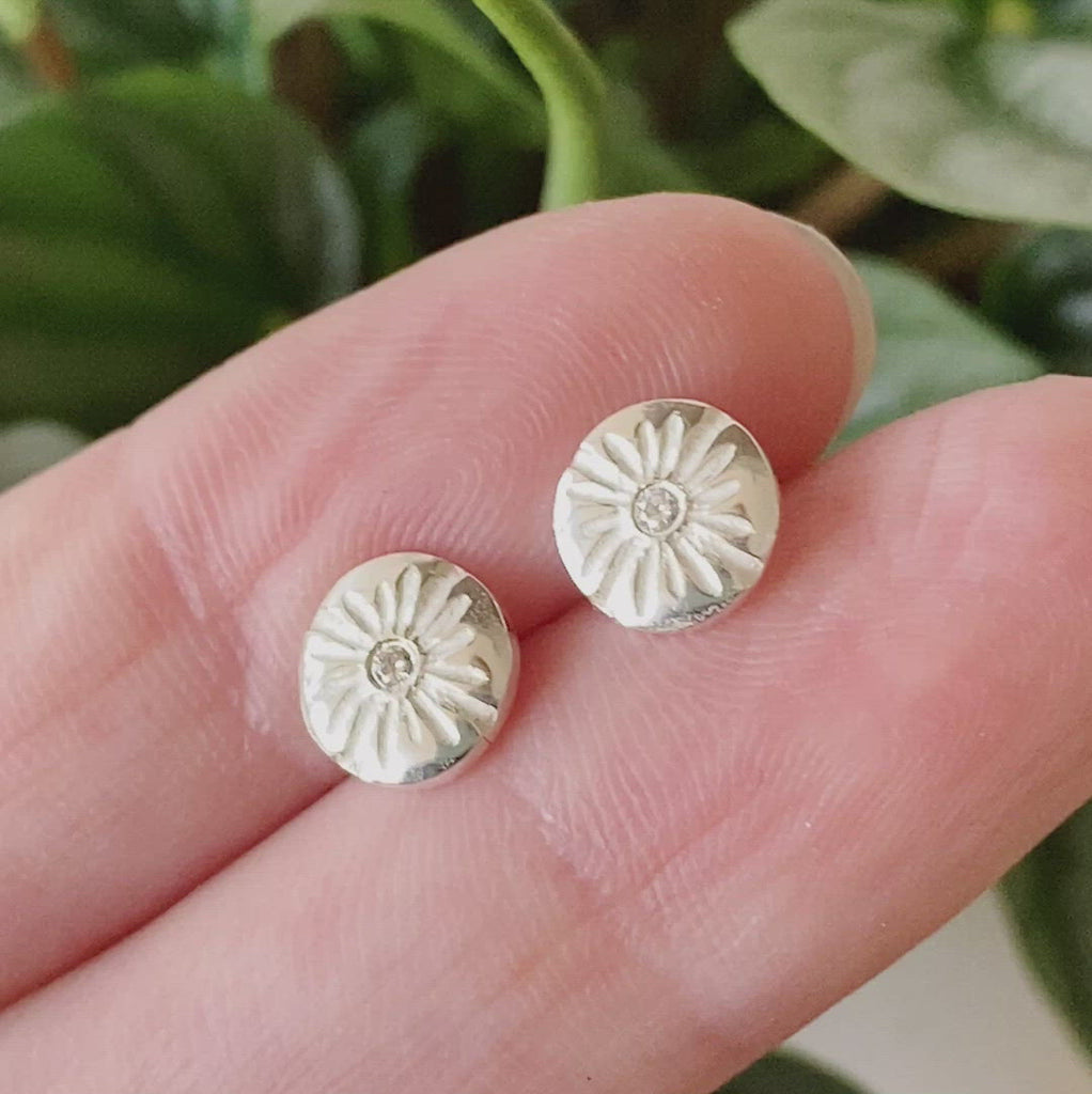 Small Lucia Diamond Stud Earrings between two fingers by Corey Egan