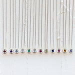 Sterling silver aurora necklaces with birthstones garnet for January,  amethyst for February, aquamarine for March, diamond for April, emerald for May, moonstone for June, ruby for July, peridot for August, blue sapphire for September, pink tourmaline for October, citrine for November, and tanzanite for December