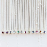 Sterling silver aurora necklaces with birthstones garnet for January,  amethyst for February, aquamarine for March, diamond for April, emerald for May, moonstone for June, ruby for July, peridot for August, blue sapphire for September, pink tourmaline for October, citrine for November, and tanzanite for December