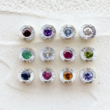 Sterling silver aurora pendants with birthstones garnet for January,  amethyst for February, aquamarine for March, diamond for April, emerald for May, moonstone for June, ruby for July, peridot for August, blue sapphire for September, pink tourmaline for October, citrine for November, and tanzanite for December